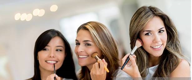 Beautiful group of happy women applying make-up